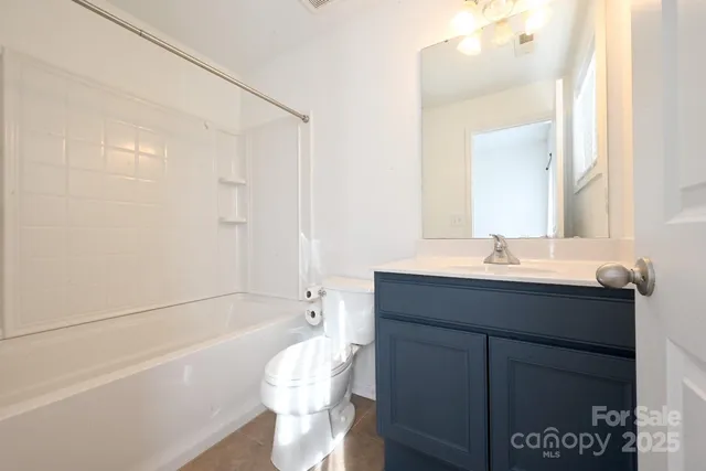 a bathroom with a sink mirror toilet and bathtub