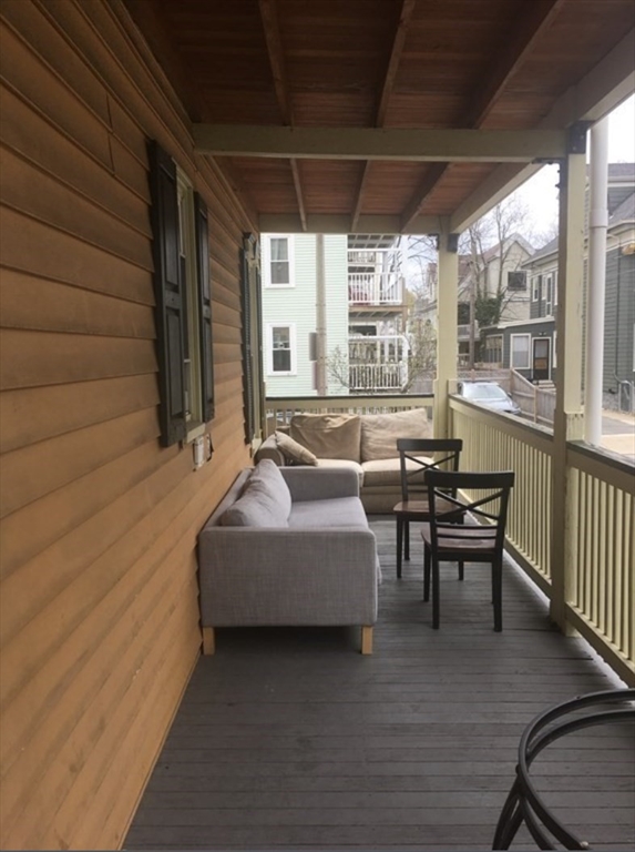 19 Pleasant Street, Unit 2 Boston, MA 02125 - Photo 11 of 11 a balcony with furniture and wooden floor