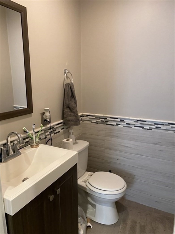 19 Pleasant Street, Unit 2 Boston, MA 02125 - Photo 6 of 11 a bathroom with a toilet sink and mirror