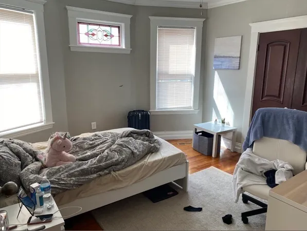 a bedroom with furniture and a window