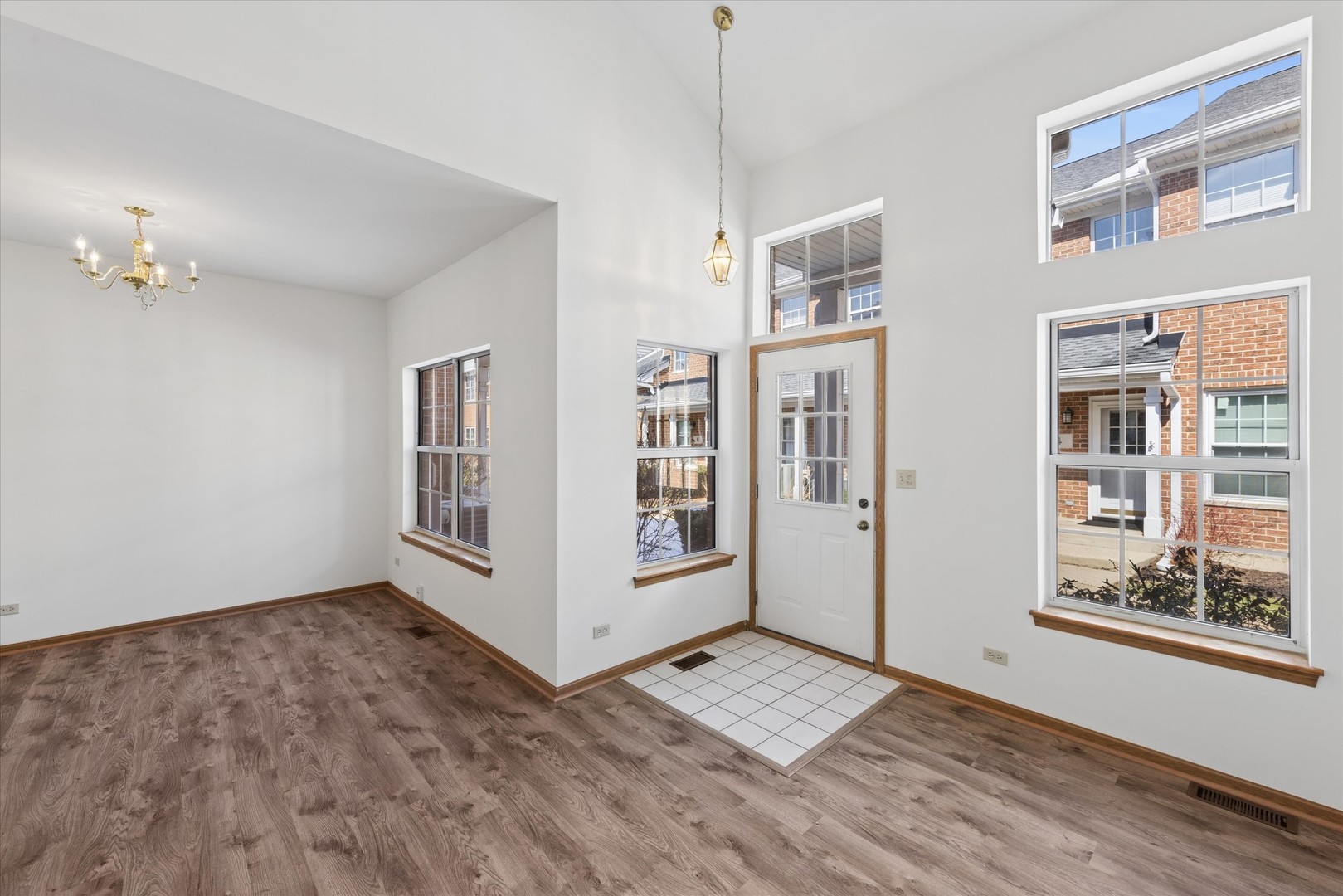 3 Dewalt Court Elmhurst, IL 60126 - Photo 2 of 17 a view of an empty room with a window and wooden floor