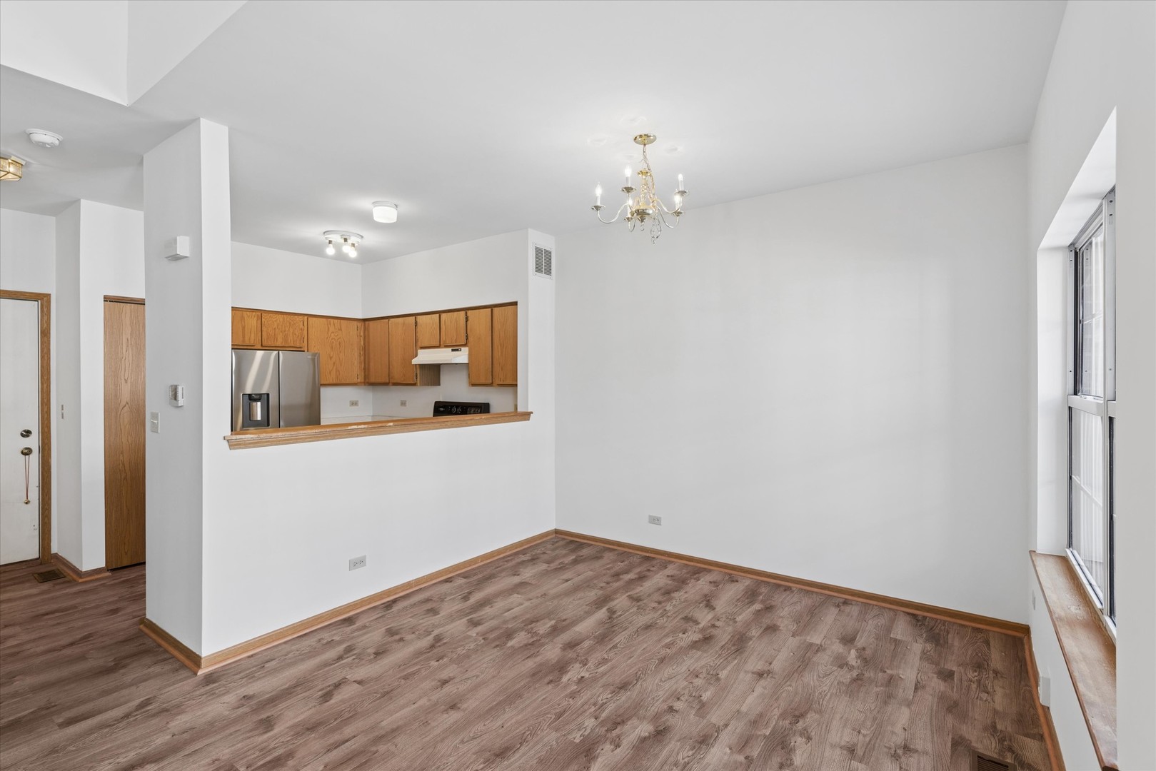 3 Dewalt Court Elmhurst, IL 60126 - Photo 3 of 17 wooden floor in an empty room with a window