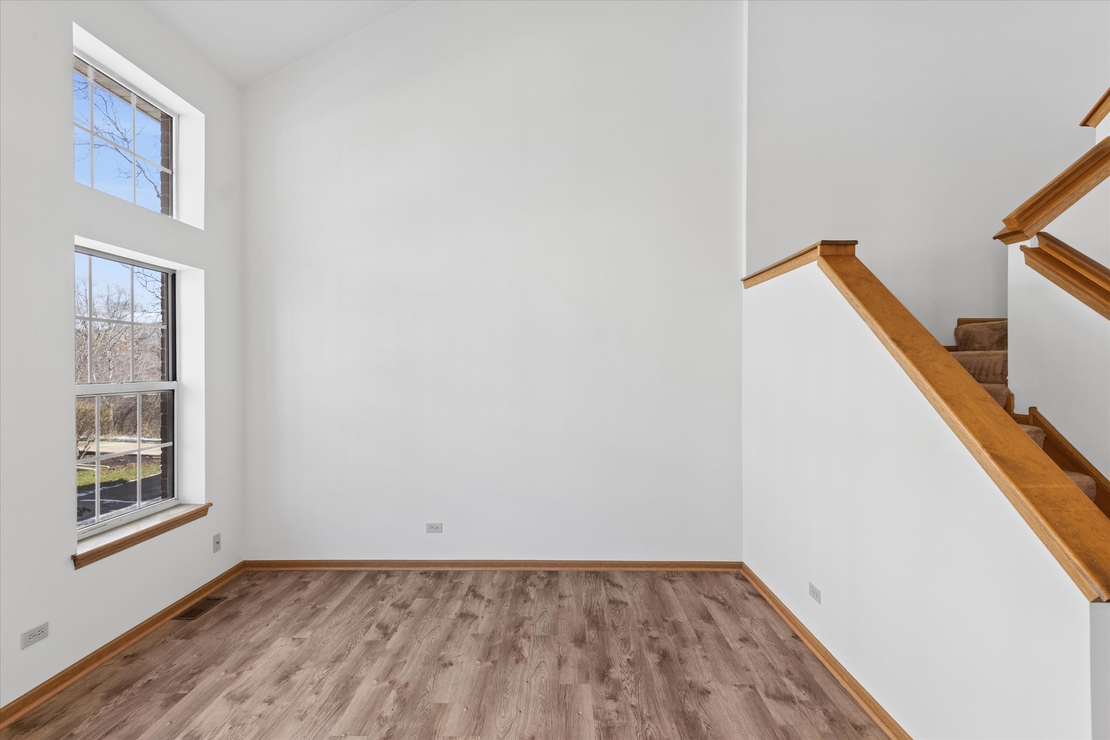 3 Dewalt Court Elmhurst, IL 60126 - Photo 6 of 17 a view of an empty room with wooden floor and a window