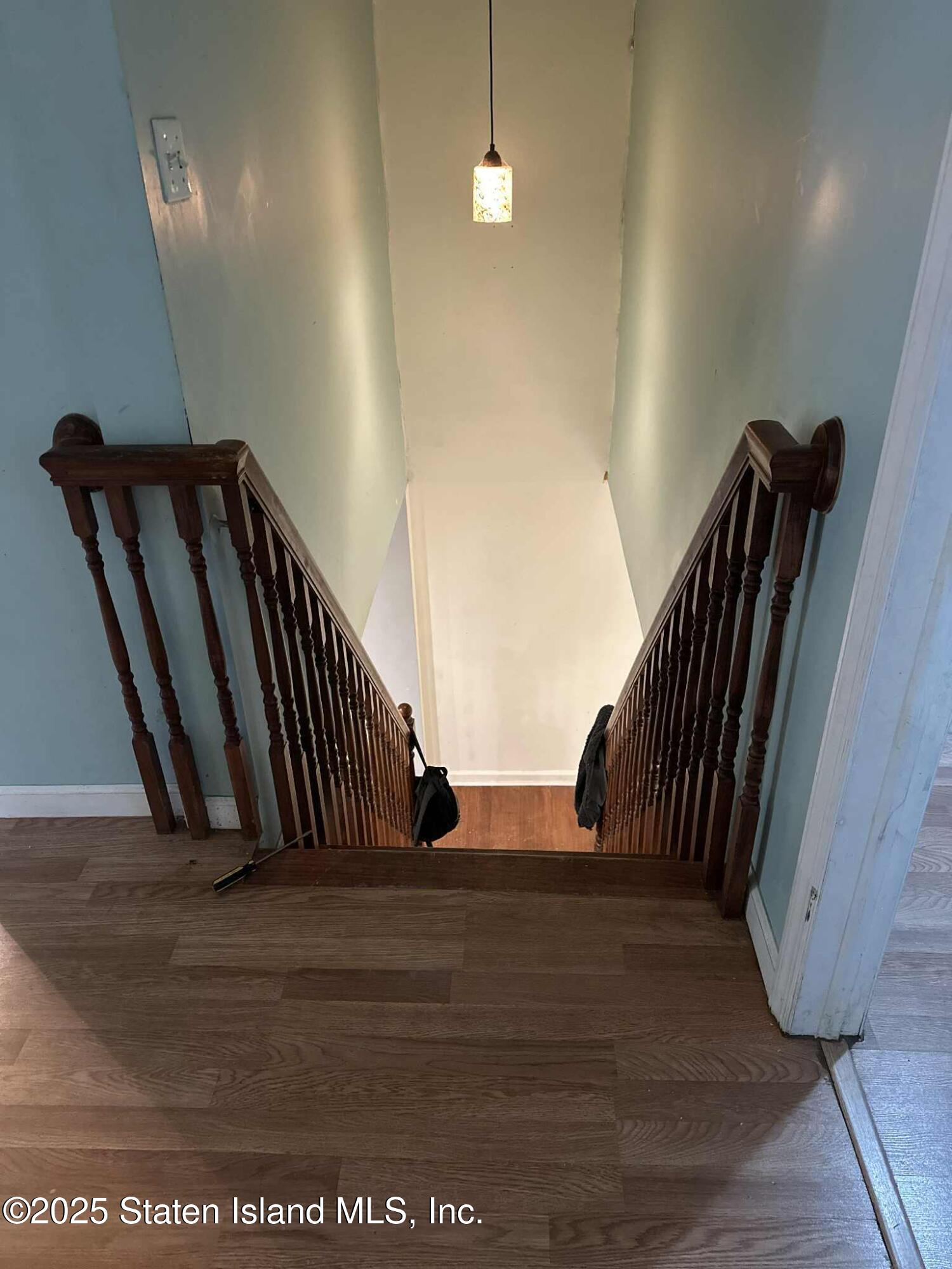 267 Gordon Street Staten Island, NY 10304 - Photo 16 of 37 a view of staircase with wooden floor and chair