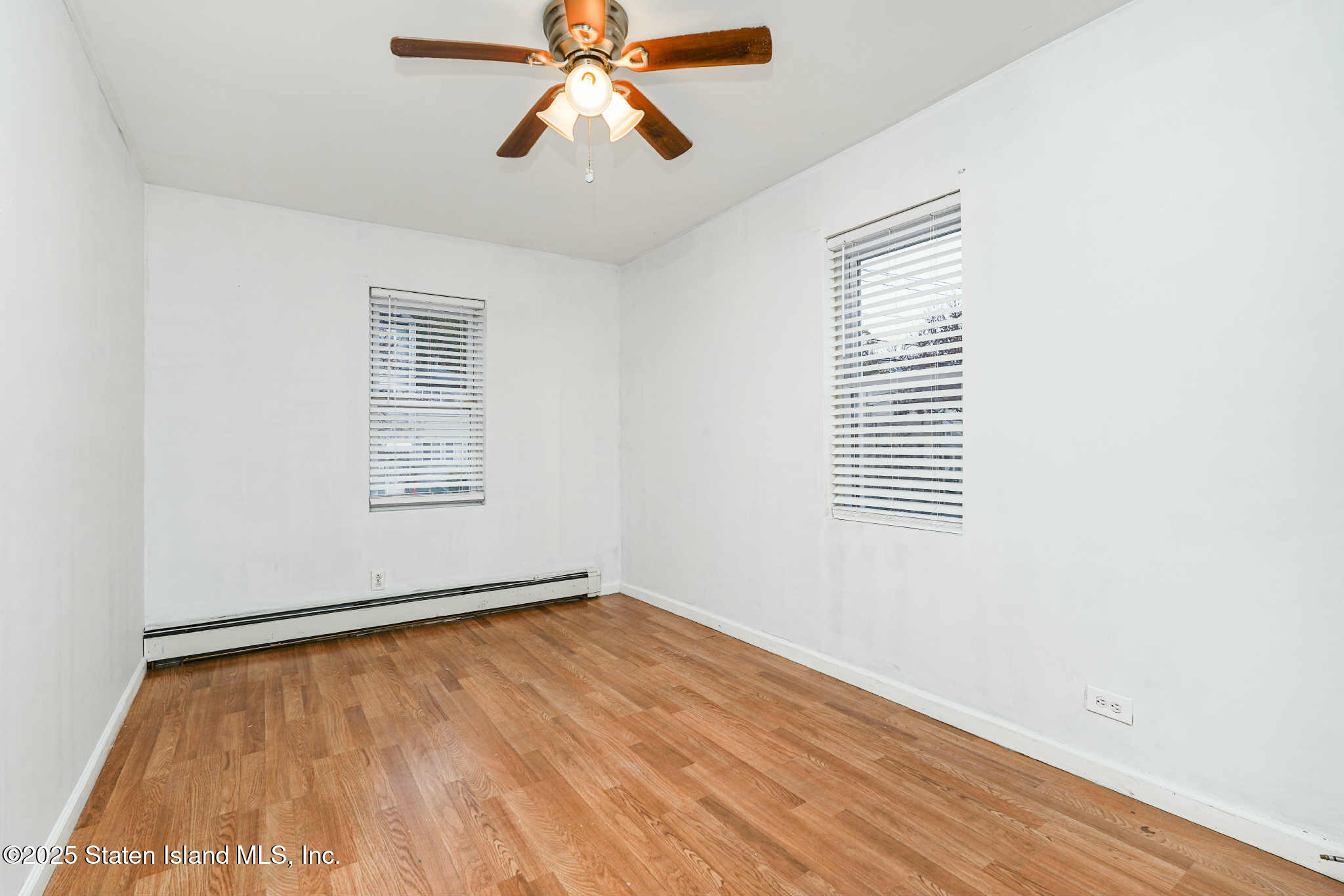 267 Gordon Street Staten Island, NY 10304 - Photo 19 of 37 an empty room with windows and fan