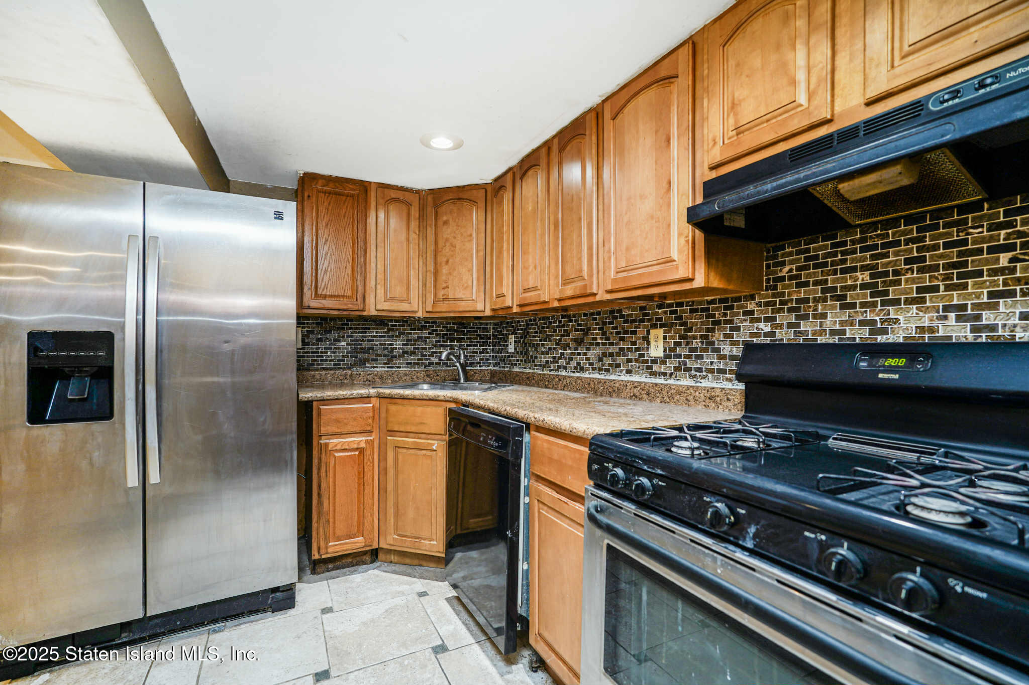267 Gordon Street Staten Island, NY 10304 - Photo 7 of 37 a kitchen with stainless steel appliances granite countertop a stove and a refrigerator