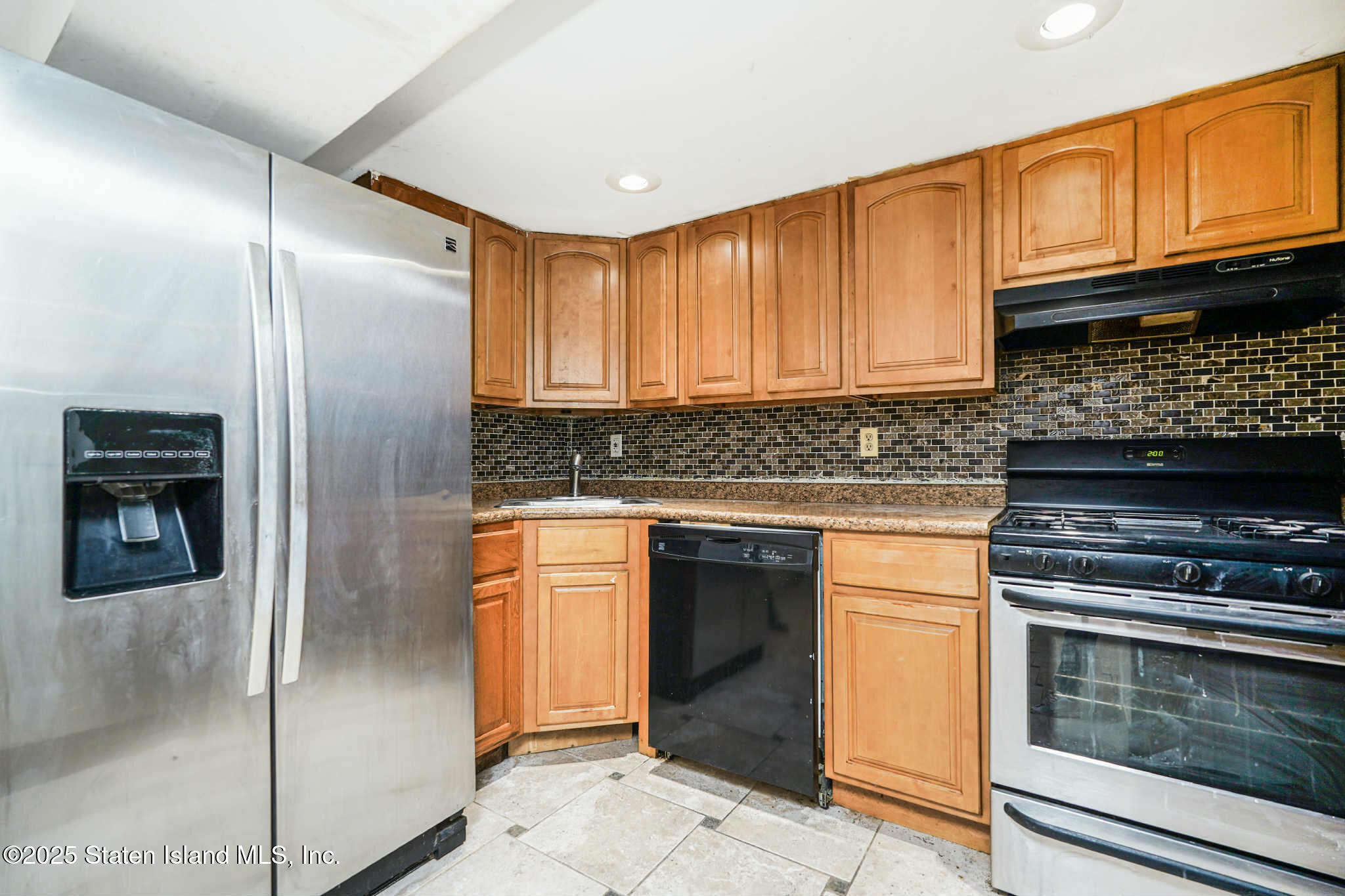 267 Gordon Street Staten Island, NY 10304 - Photo 8 of 37 a kitchen with stainless steel appliances granite countertop a refrigerator stove and cabinets