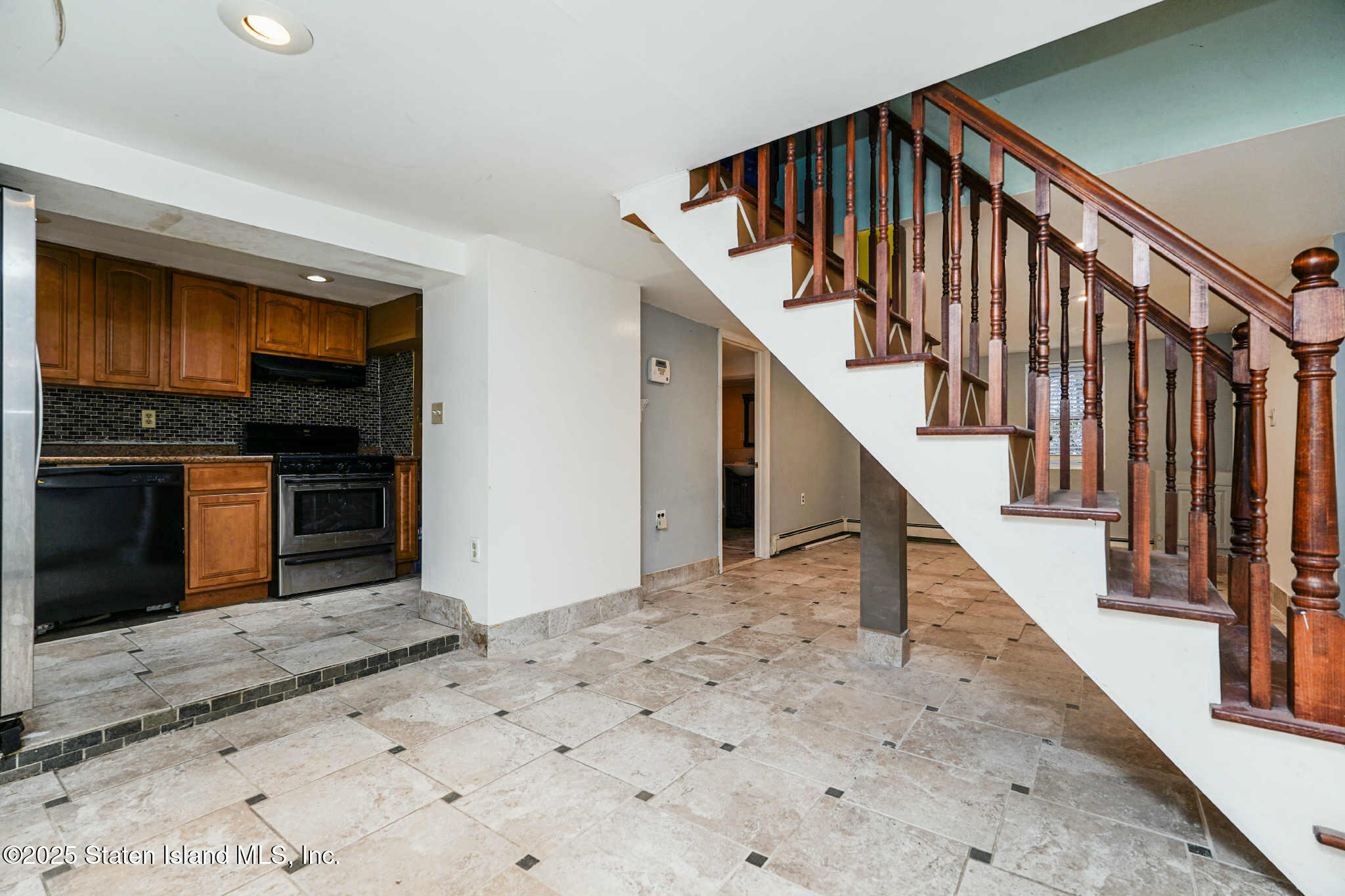 267 Gordon Street Staten Island, NY 10304 - Photo 10 of 37 a view of a hallway with wooden floor and staircase