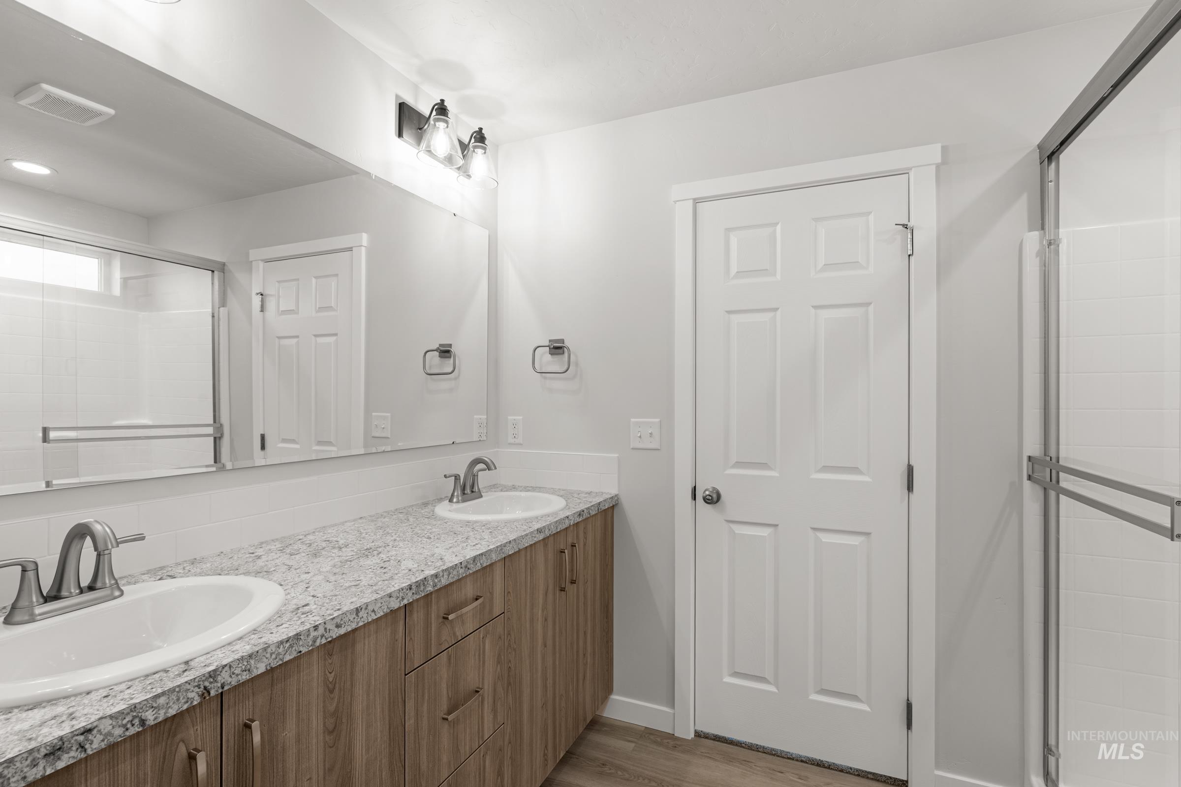 13693 Redway Court Caldwell, ID 83607 - Photo 23 of 25 Full bath featuring a shower stall, double vanity, and light wood finished floors