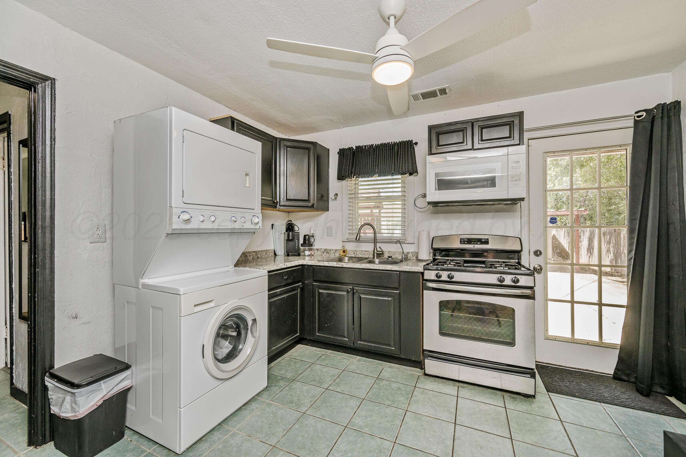3620 South Hayden Street Amarillo, TX 79110 - Photo 9 of 25 a kitchen with a stove top oven sink and cabinets