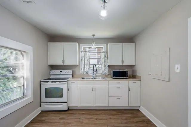 a kitchen with stainless steel appliances a stove top oven