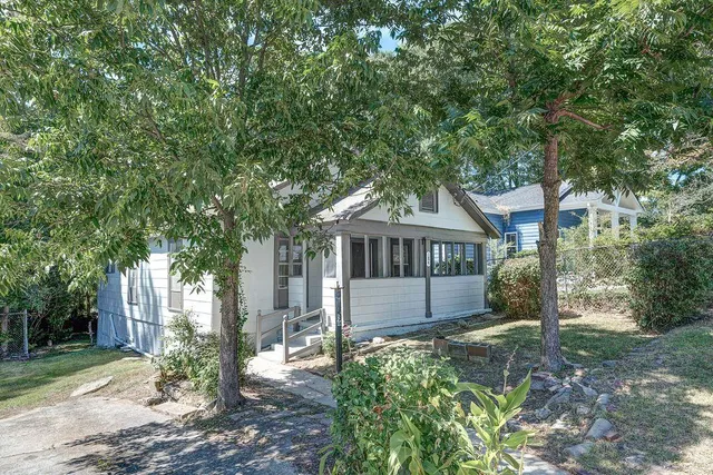 a house that has a tree in front of it