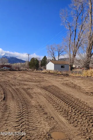 a view of dirt road with a building
