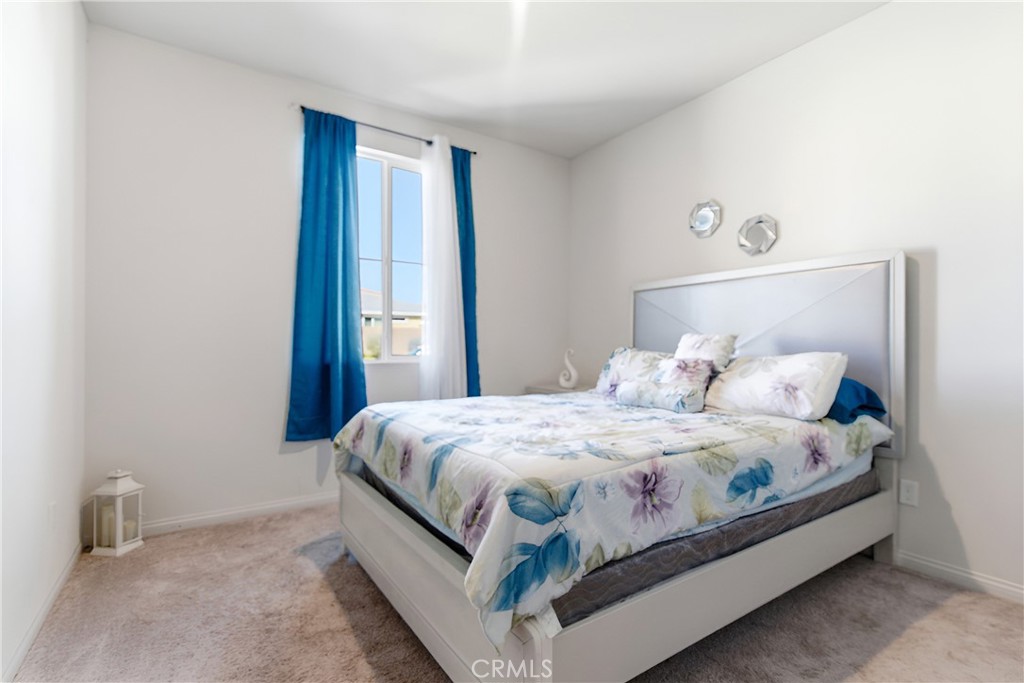 15594 Raptor Road Moreno Valley, CA 92551 - Photo 11 of 53 a bedroom with a bed and window