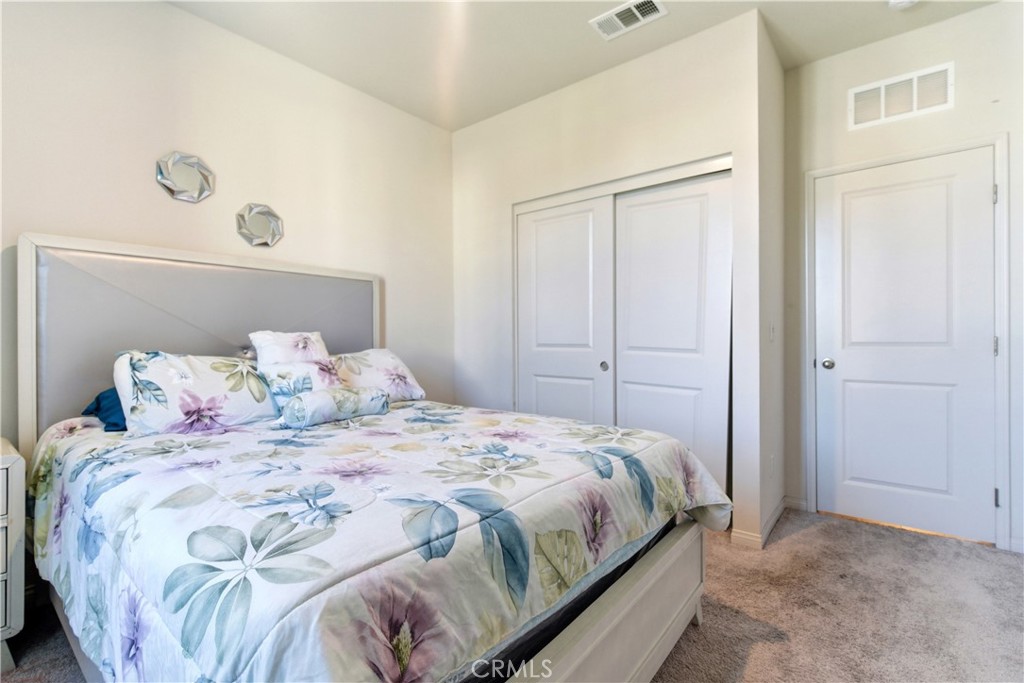 15594 Raptor Road Moreno Valley, CA 92551 - Photo 12 of 53 a bedroom with a bed and a window