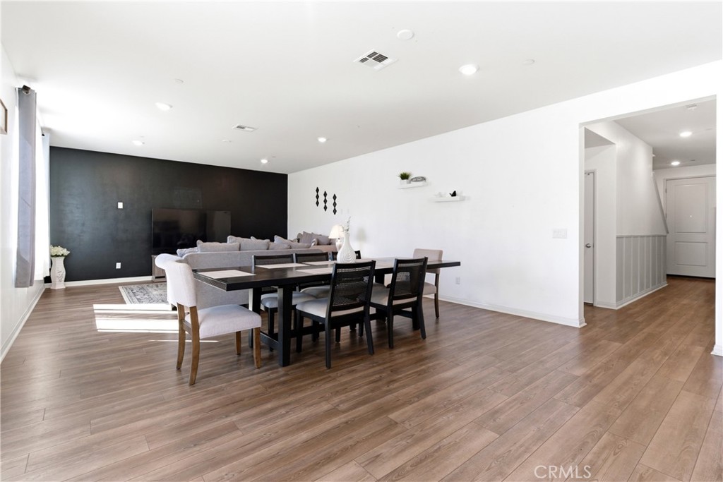 15594 Raptor Road Moreno Valley, CA 92551 - Photo 21 of 53 a view of a dining room with furniture and wooden floor