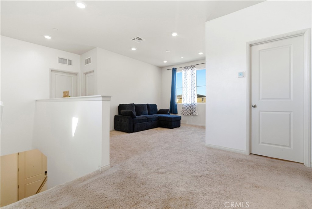 15594 Raptor Road Moreno Valley, CA 92551 - Photo 26 of 53 a living room with furniture and a refrigerator