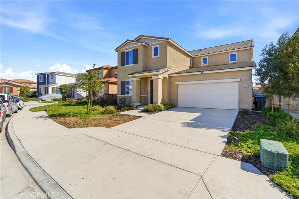 15594 Raptor Road Moreno Valley, CA 92551 - Photo 3 of 53 a front view of a house with a yard and garage