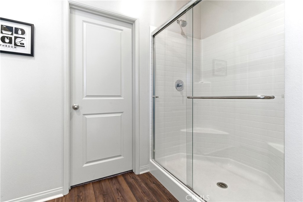 15594 Raptor Road Moreno Valley, CA 92551 - Photo 41 of 53 a bathroom with a glass shower door