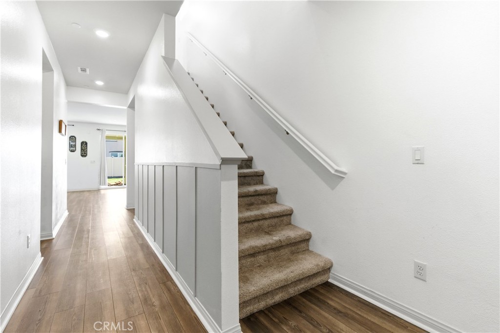 15594 Raptor Road Moreno Valley, CA 92551 - Photo 6 of 53 a view of a hallway with wooden floor and entryway