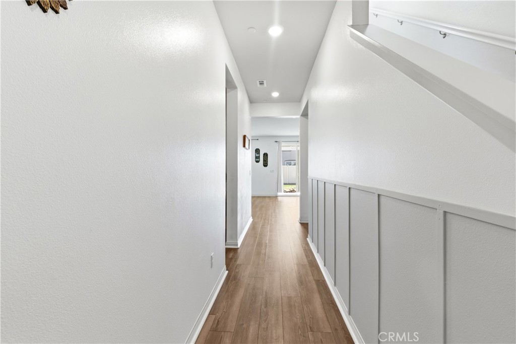 15594 Raptor Road Moreno Valley, CA 92551 - Photo 7 of 53 a view of a hallway with wooden floor