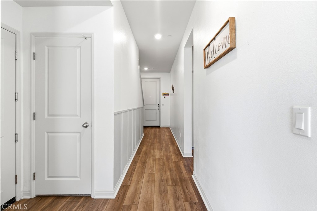 15594 Raptor Road Moreno Valley, CA 92551 - Photo 8 of 53 a view of a hallway with wooden floor and staircase
