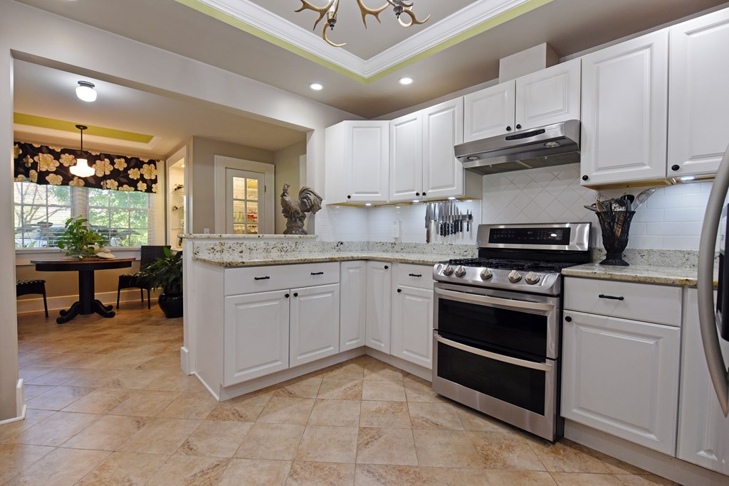 63 Loving Road Morganton, GA 30560 - Photo 8 of 58 a kitchen with stainless steel appliances granite countertop a stove a sink and a microwave