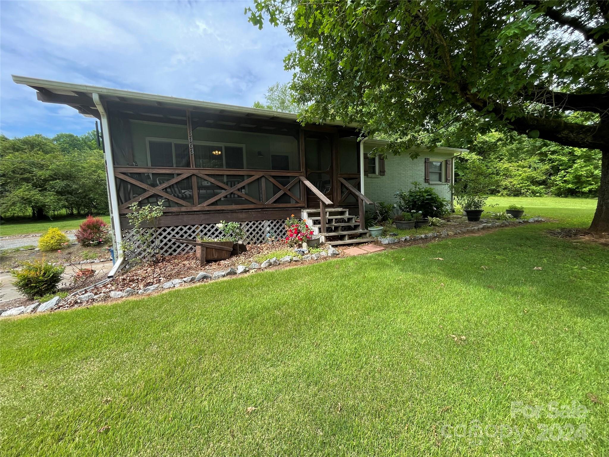 3063 Rocky Road Lenoir, NC 28645 - Photo 2 of 11 a front view of a house with garden