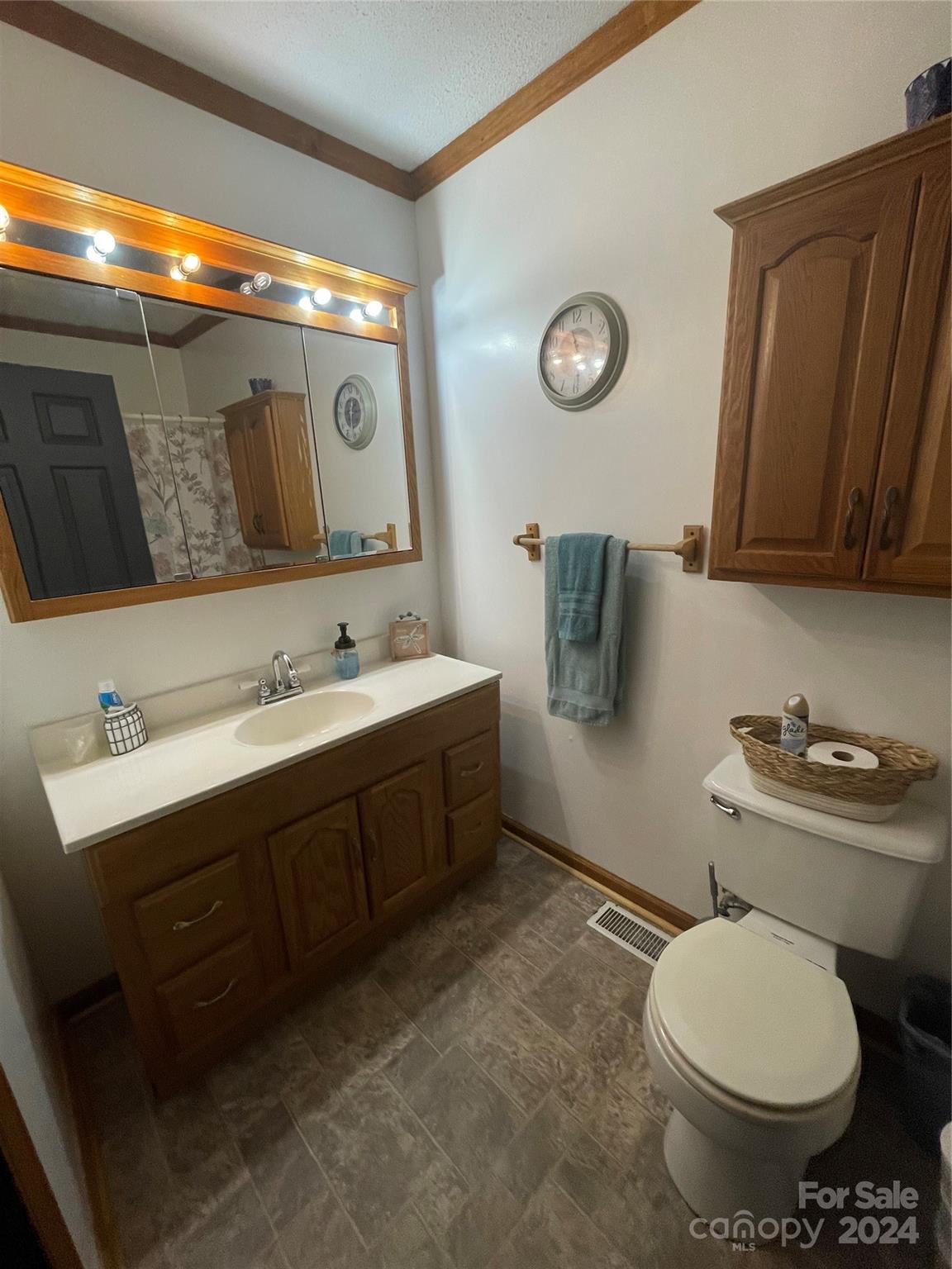 3063 Rocky Road Lenoir, NC 28645 - Photo 6 of 11 a bathroom with a toilet sink vanity and mirror