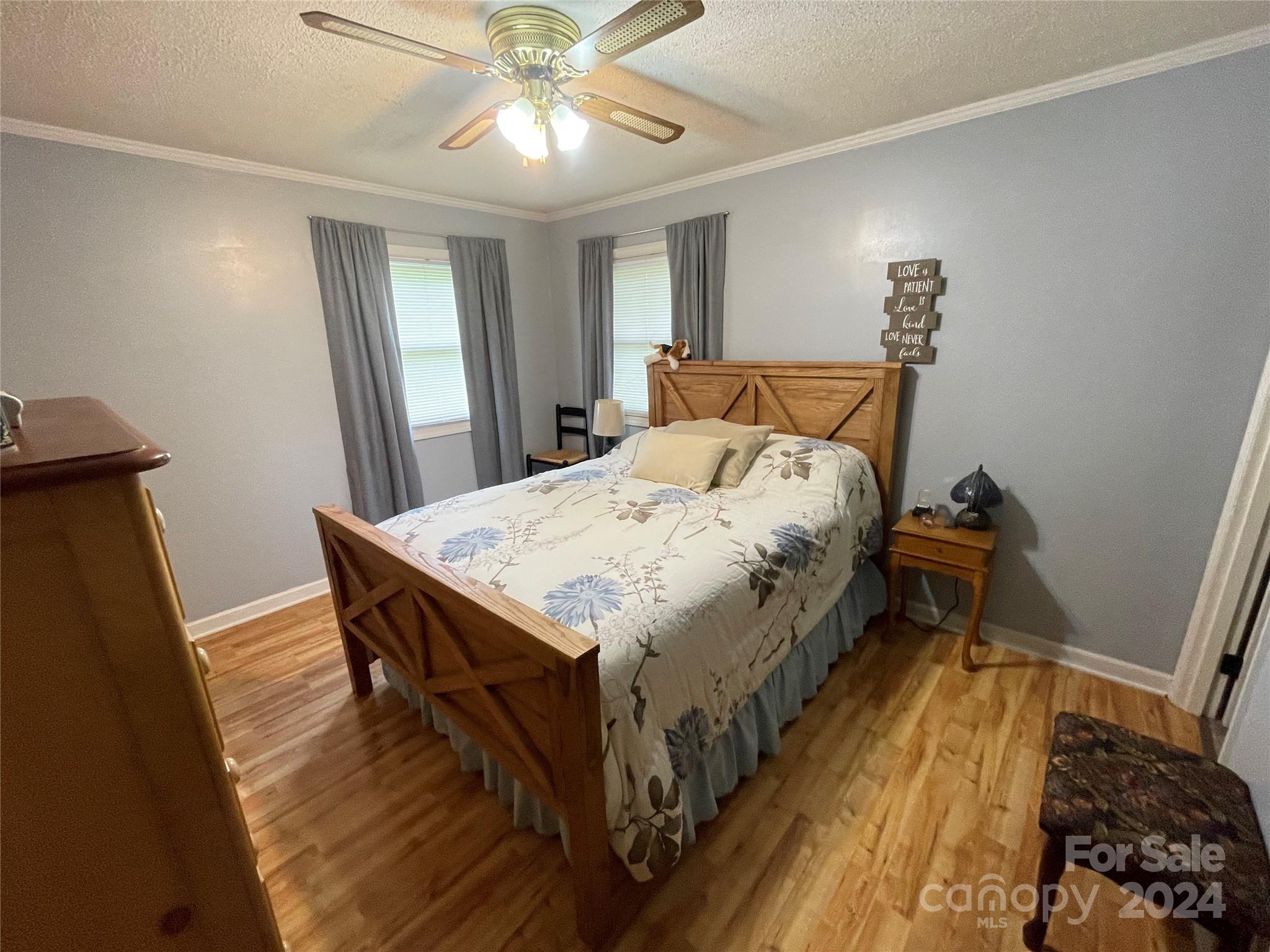 3063 Rocky Road Lenoir, NC 28645 - Photo 8 of 11 a bedroom with bed and wooden floor