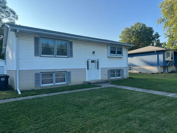 a view of house with backyard