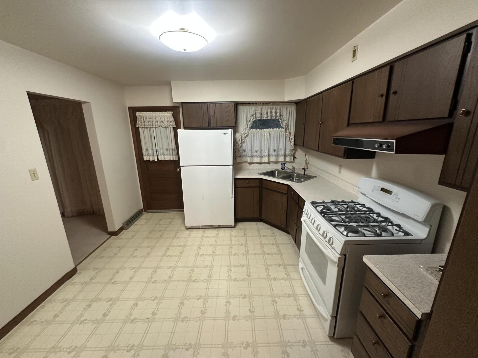 240 Rush Court Hobart, IN 46342 - Photo 5 of 19 a kitchen with a refrigerator a stove top oven a counter space and cabinets