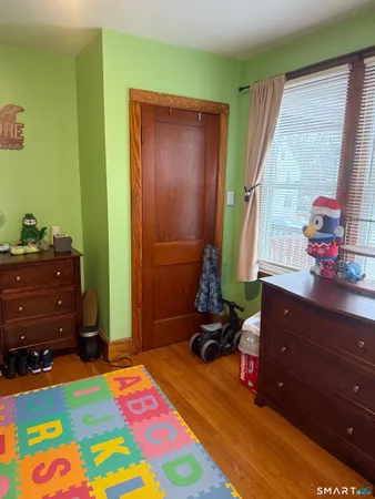 a bedroom with a bed and a dresser