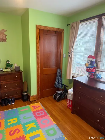 a bedroom with a bed and a dresser