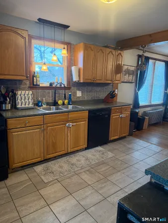 a kitchen with stainless steel appliances granite countertop a sink counter space cabinets and a large window