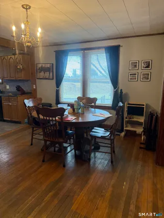 a view of a dining room with furniture and wooden floor