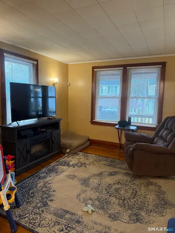 a living room with a flat screen tv and a fireplace