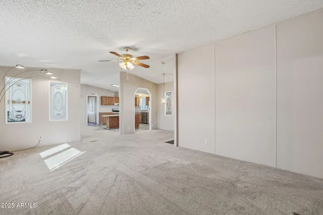 a view of a livingroom with a dishwasher cabinets and a large window