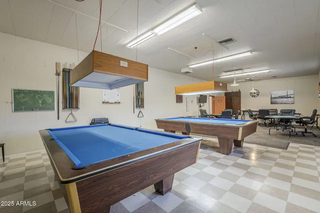 a room with furniture pool table and window