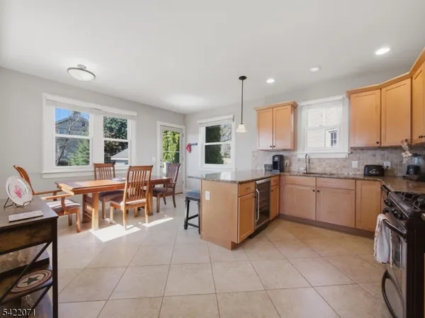 a kitchen with a table chairs sink and cabinets