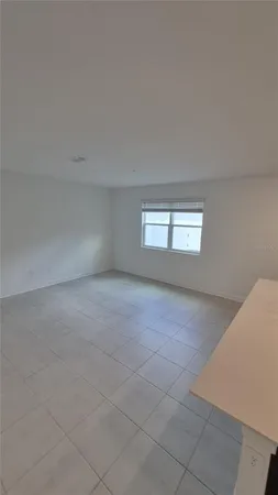 a view of an empty room and a window