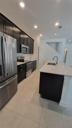 a kitchen with a sink and stainless steel appliances
