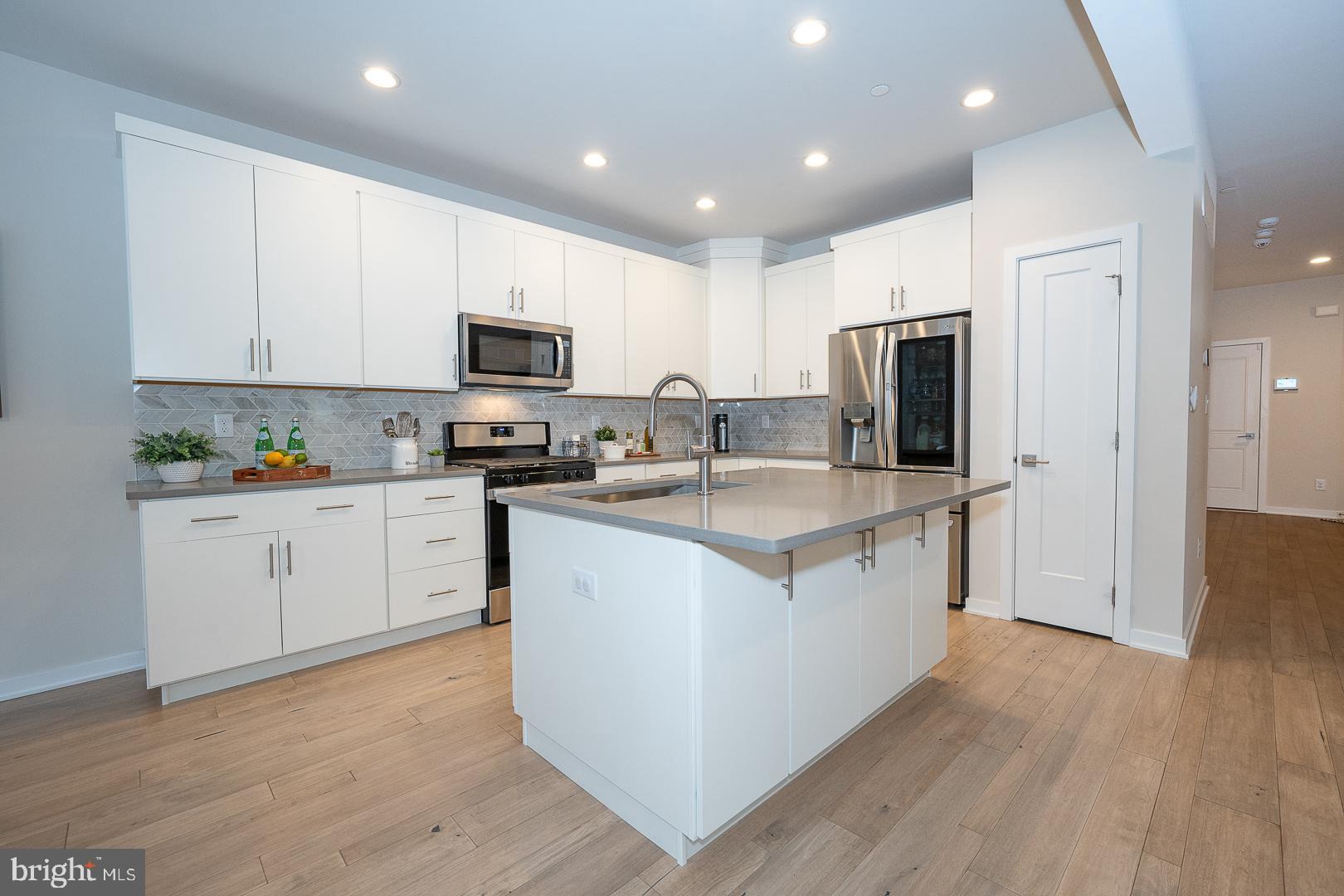 724 Switchman Road Media, PA 19063 - Photo 18 of 70 a kitchen with granite countertop a refrigerator stove top oven and cabinets