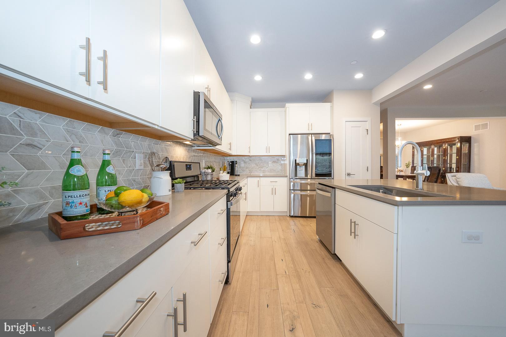 724 Switchman Road Media, PA 19063 - Photo 20 of 70 a kitchen with stainless steel appliances granite countertop sink stove refrigerator and cabinets