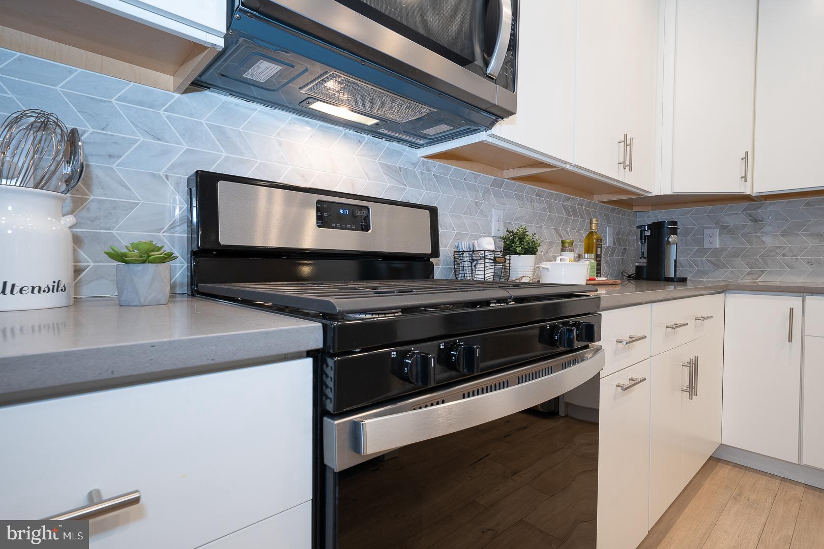 724 Switchman Road Media, PA 19063 - Photo 22 of 70 a kitchen with stainless steel appliances a stove a sink and a microwave