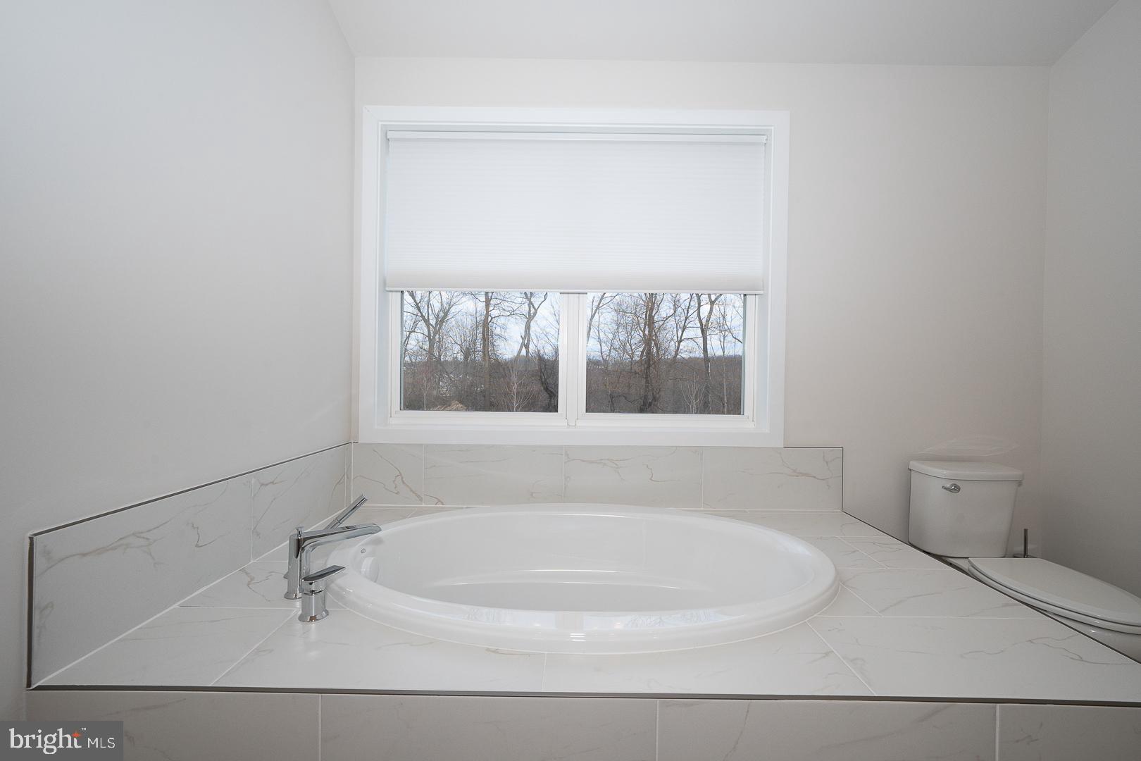 724 Switchman Road Media, PA 19063 - Photo 34 of 70 a white bath tub sitting in a bathroom
