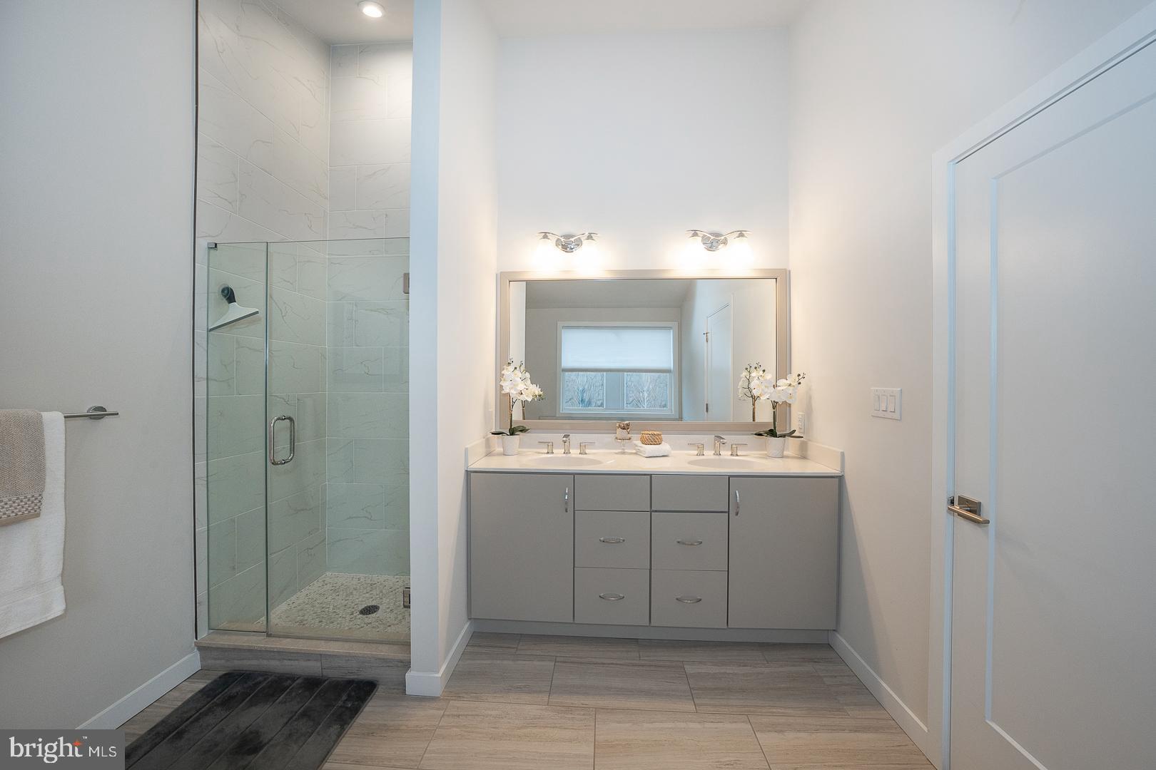 724 Switchman Road Media, PA 19063 - Photo 35 of 70 a bathroom with a double vanity sink mirror and shower