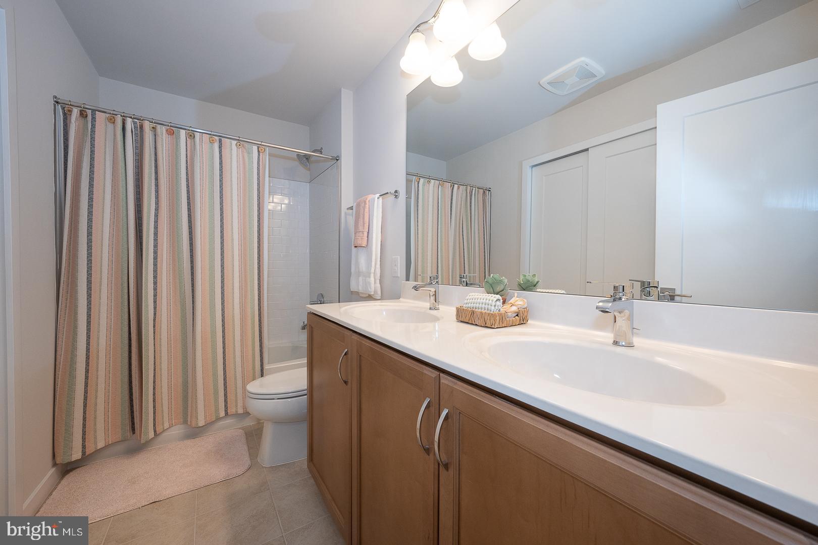 724 Switchman Road Media, PA 19063 - Photo 46 of 70 a bathroom with a double vanity sink and a mirror
