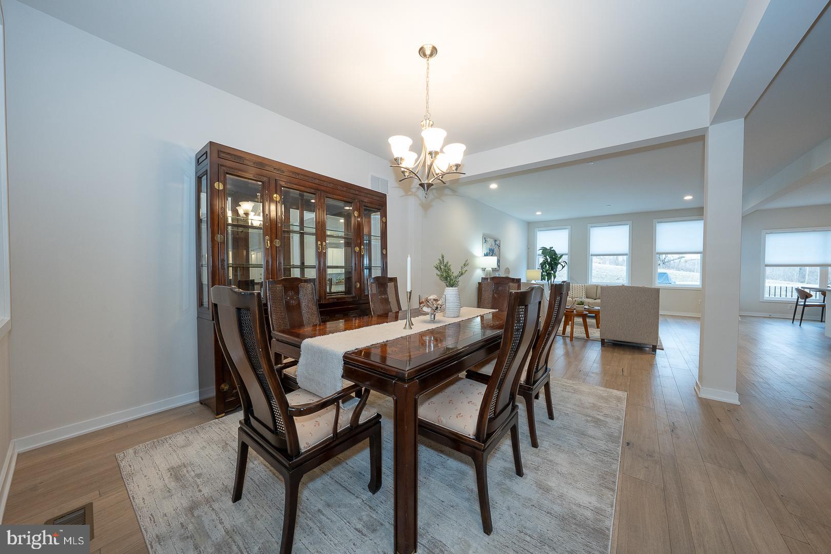 724 Switchman Road Media, PA 19063 - Photo 6 of 70 a dining room with wooden floor a chandelier a wooden table and chairs