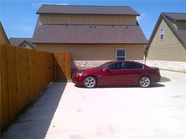 a front view of a house with parking space